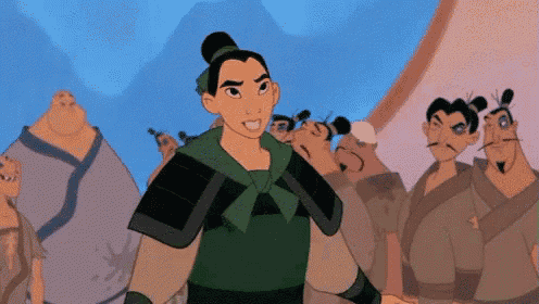 a woman in a green armor is standing in front of a group of men .