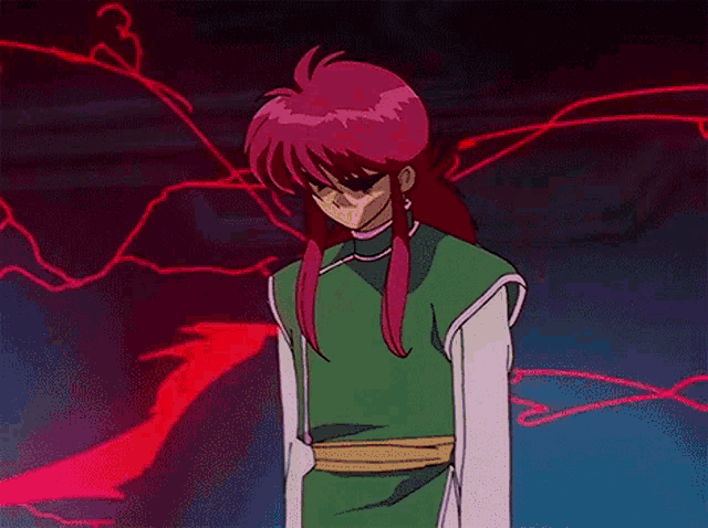 a man with pink hair is standing in a dark room .