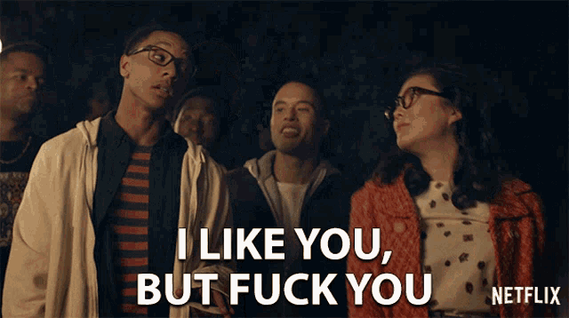 a group of people are standing in a dark room and one of them is saying i like you but fuck you