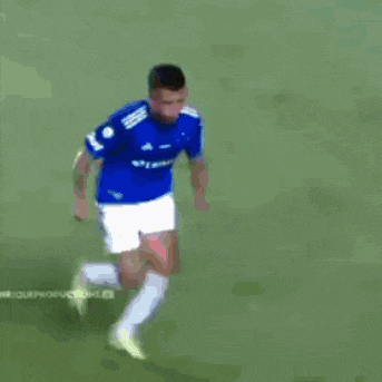 a soccer player with the number 98 on his back is being tackled by another player