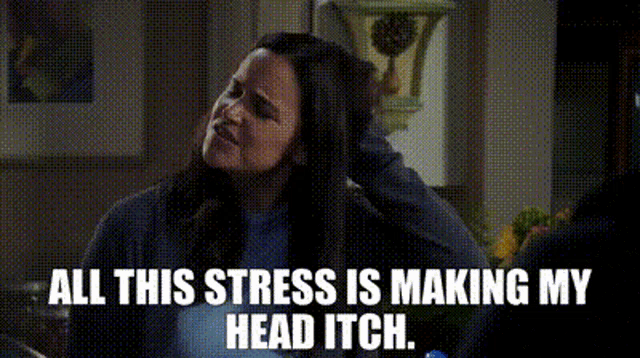 a woman is sitting in a kitchen talking to a man and says `` all this stress is making my head itch . ``
