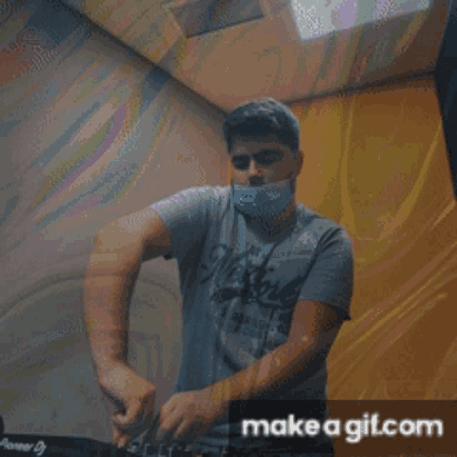 a man wearing a mask is playing music on a pioneer dj turntable