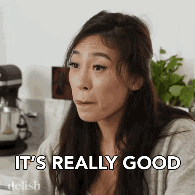 a woman says " it 's really good " in front of a kitchen mixer