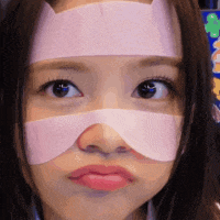 a close up of a woman 's face with a bandage on her forehead