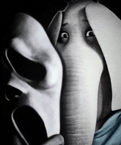 a black and white photo of an elephant with a scream mask on its face