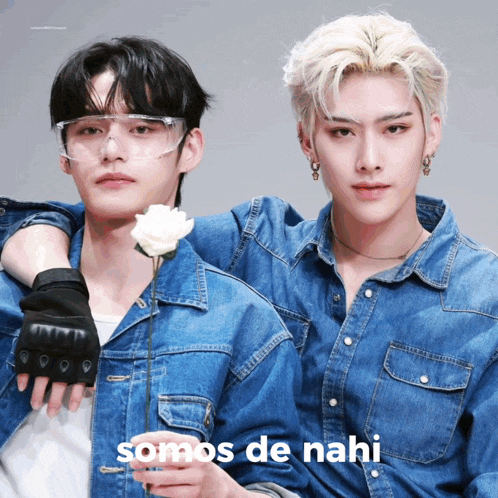 two young men wearing denim jackets and goggles holding a white rose with the words somos de nahi written below them