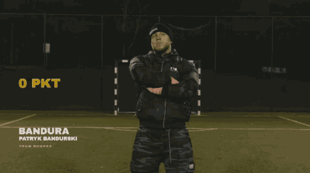a man stands on a soccer field with the word bandura in the corner