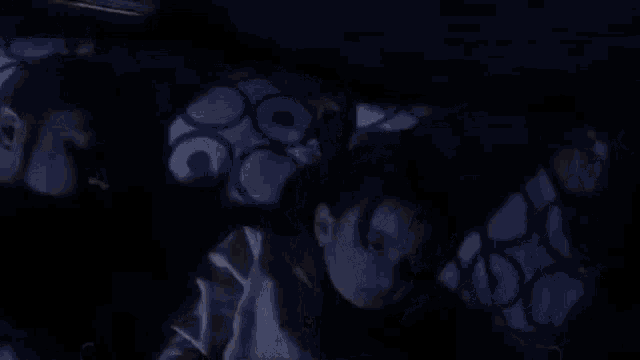 a man and a child are sleeping in a bed .