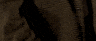 a close up of a man 's hand holding a gun in a holster