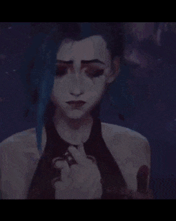 a man and a woman are hugging each other . the woman has blue hair .