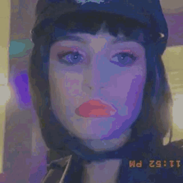 a woman wearing a police hat and a helmet is looking at the camera .
