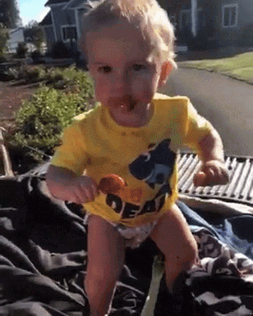 a little boy wearing a yellow shirt that says deaf