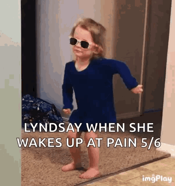 a little girl wearing sunglasses is dancing in a hallway with the caption lyndsay when she wakes up