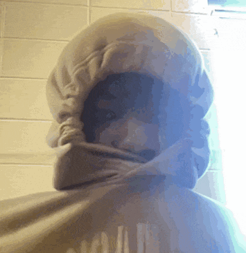 a person wearing a hooded sweatshirt with the word squad on the back