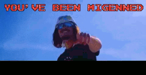 a man wearing sunglasses and a hat is pointing at the camera with the words you 've been migenned behind him
