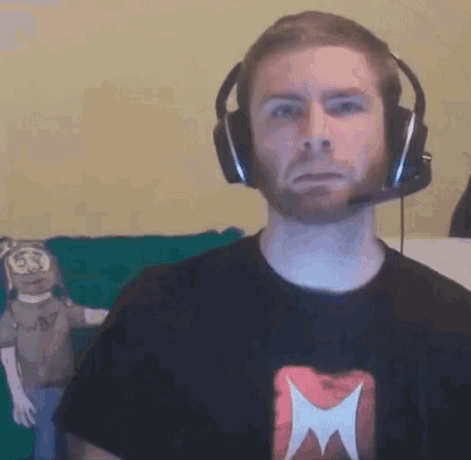 a man with a beard wearing headphones and a black shirt with a x on it