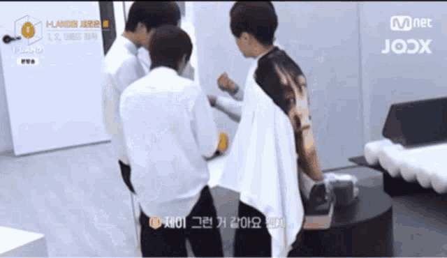 a group of young men are standing in a room with mnet written on the bottom