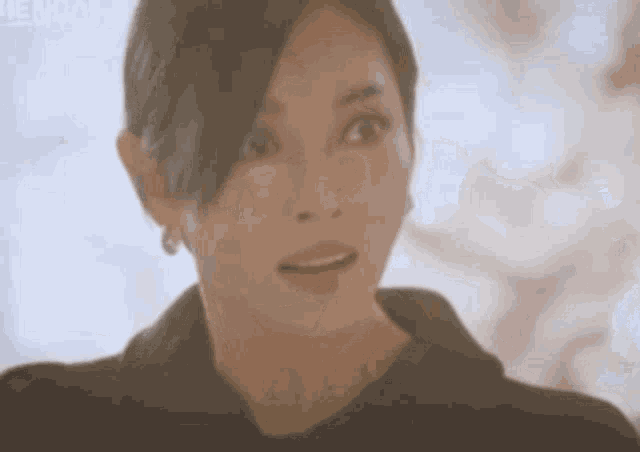 a close up of a woman 's face with a surprised expression .