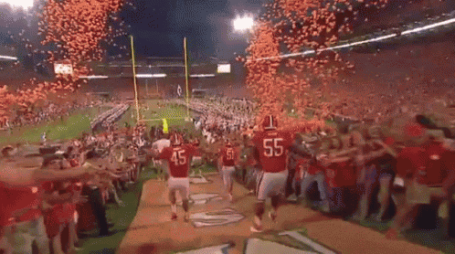 a football player with the number 45 on the back of his jersey walks off the field