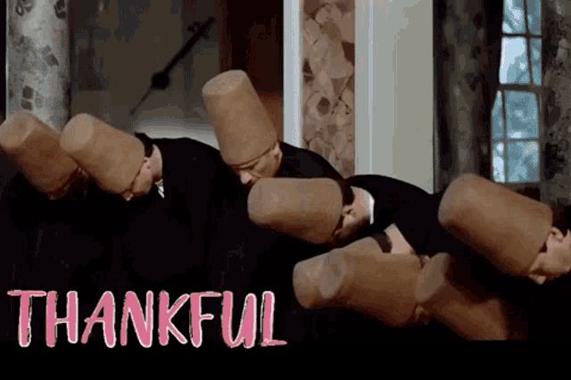 a group of men are dancing in front of a sign that says " thankful "
