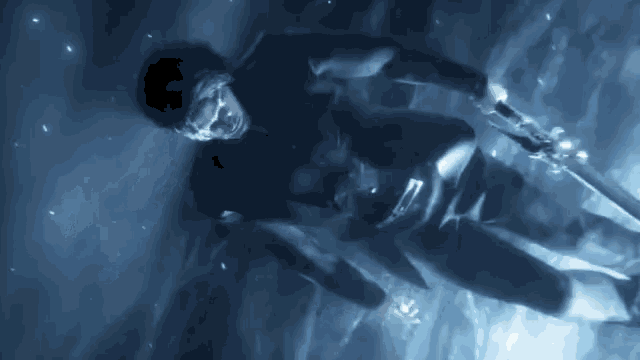 a man is floating in the water holding a sword in his hand .