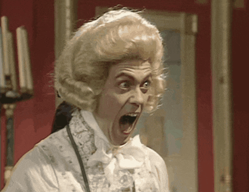 a man wearing a wig and a white shirt has his mouth open