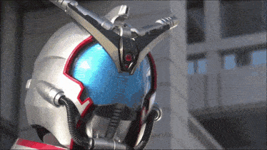 a close up of a helmet with a red eye