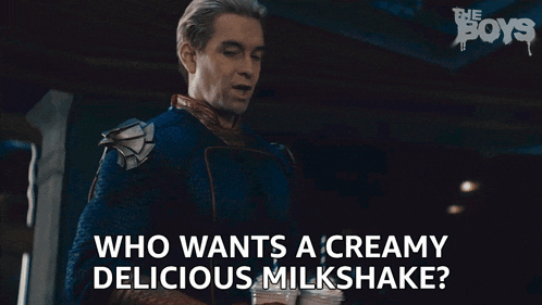 a man from the show the boys is holding a milkshake and asking who wants a creamy delicious milkshake
