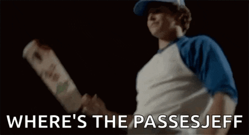 a man is holding a skateboard in his hand and the words `` where 's the passes jeff '' are visible .