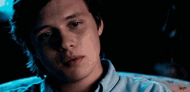 a close up of a man 's face in the dark