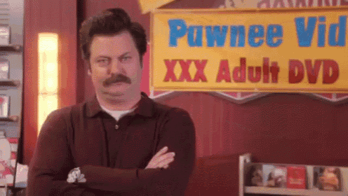 a man is standing in front of a sign that says pawnee video xxx adult dvd