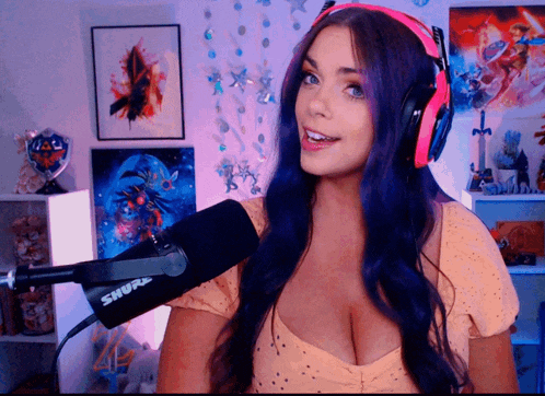 a woman wearing headphones and a shure microphone in front of her