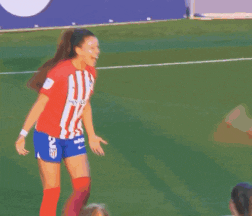 a female soccer player with the number 8 on her jersey is hugging another player