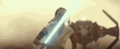 a woman is holding a light saber in front of a robot in a star wars movie .