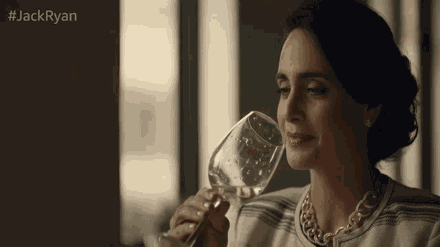 a woman drinking a glass of wine with the hashtag #jackryan