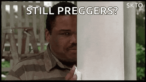 a man is peeking out from behind a wall holding a napkin and asking , `` still preggers ? ''
