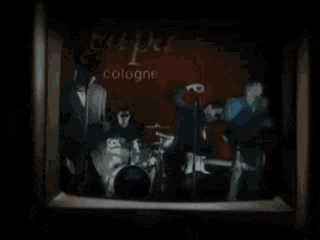 a man wearing sunglasses singing into a microphone in front of a sign that says coico