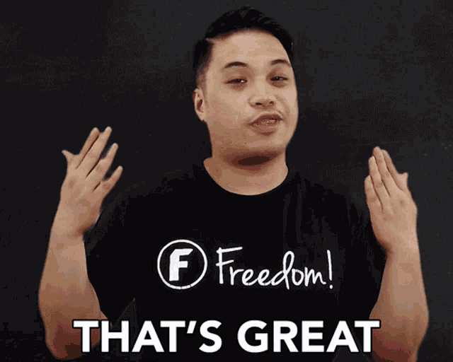 a man wearing a black shirt that says freedom