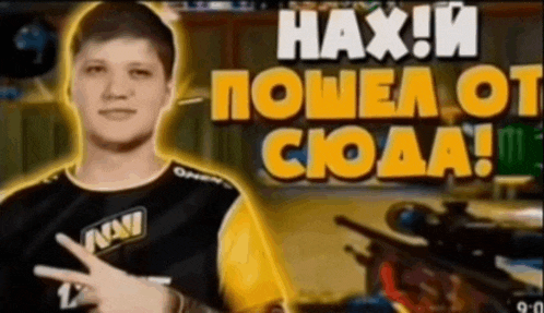 a man in a navi shirt is pointing at a sniper rifle