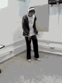 a man wearing headphones is standing in a room .