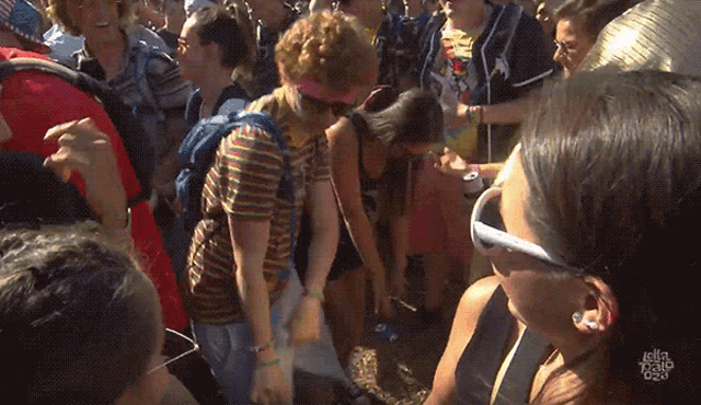 a woman wearing sunglasses stands in a crowd of people with the word julio on the bottom right