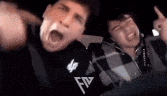a couple of men are sitting in a car with their mouths open .