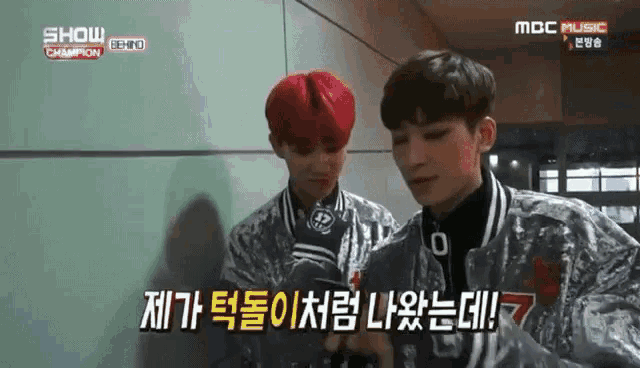 two boys with red hair are standing next to each other on a show called show champion .