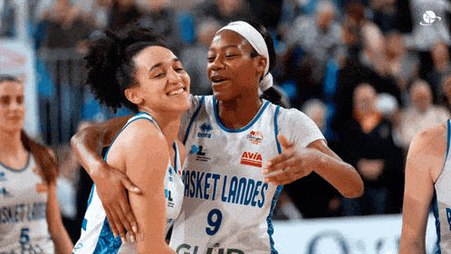 two female basketball players from basket landes hugging