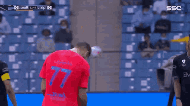 a soccer player wearing a red shirt with the number 18 on it celebrates a goal
