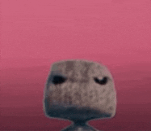 a close up of a statue with a pink background and a face on it .