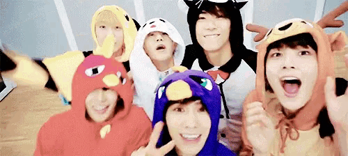 a group of young men are posing for a picture wearing costumes .