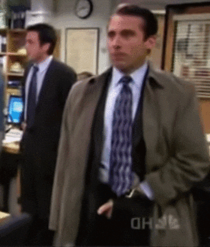 a man in a suit and tie is standing in front of a sign that says oh