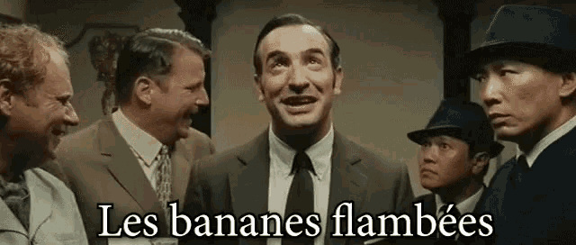 a group of men in suits and hats with the words les bananes flambees below them