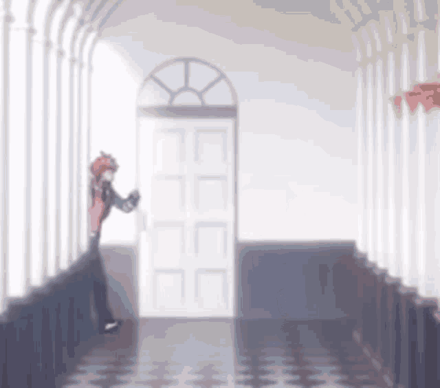 a person is standing in a hallway with a door open